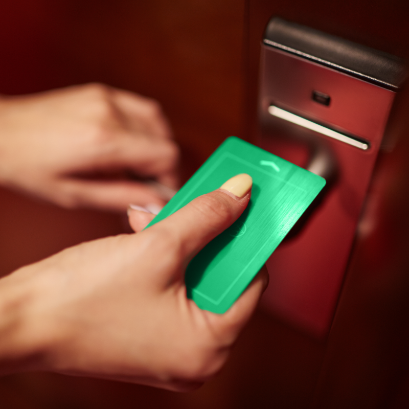 Magstripe lock with hand holding green keycard